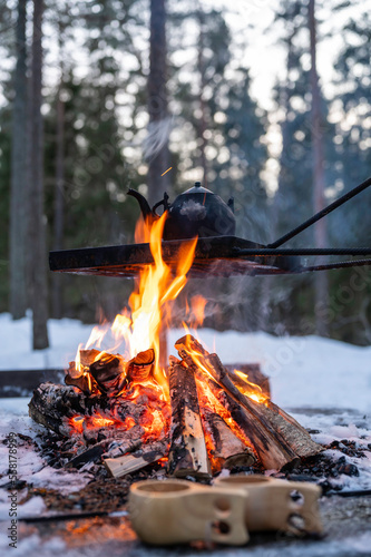 Old kettle boiling over an open fire outdoors in winter. Österbotten/Pohjanmaa, Finland