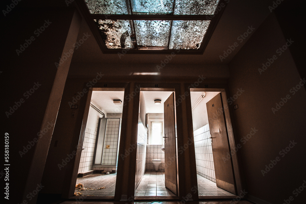 abandoned bathroom in a military barracks with a shower cubicle and a skylight in a lost place abandoned bathroom in a military barracks with a shower cubicle and a skylight in a lost place