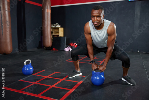 athletic man training with kettlebell in the gym