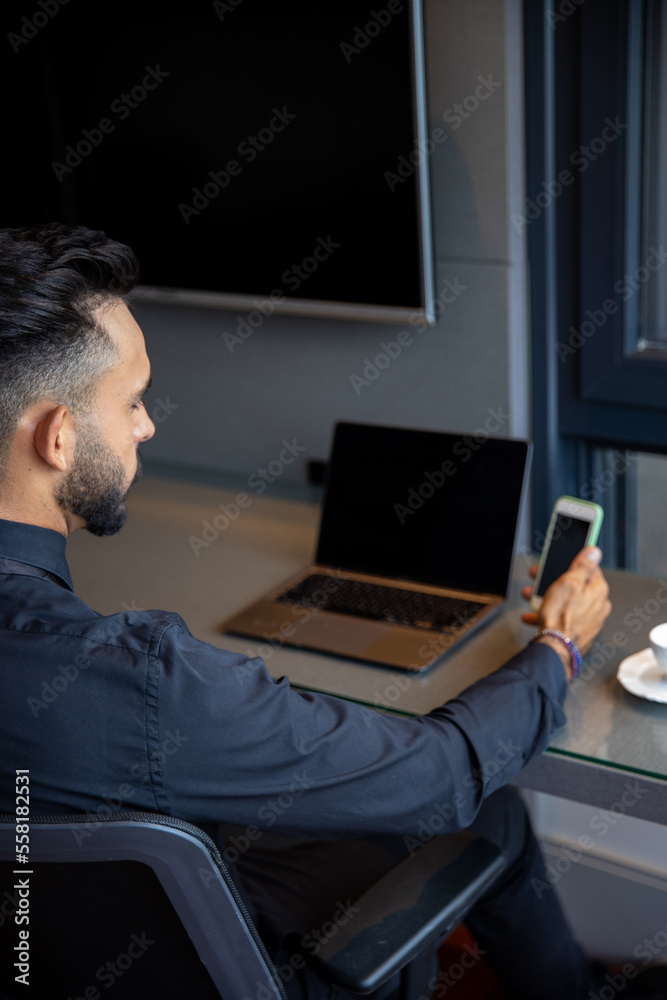 Portrait of man using smartphone in home office, top view, man typing on his phone - technology, homeoffice, entrepreneur, selling from home Portrait of man using smartphone in home office, top view, man typing on his phone - technology, homeoffice, entrepreneur, selling from home