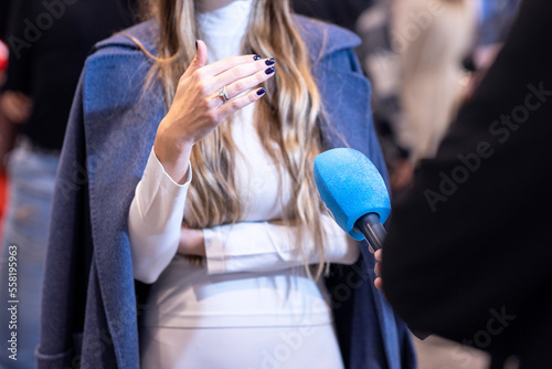 News journalist making media interview with unrecognizable female person