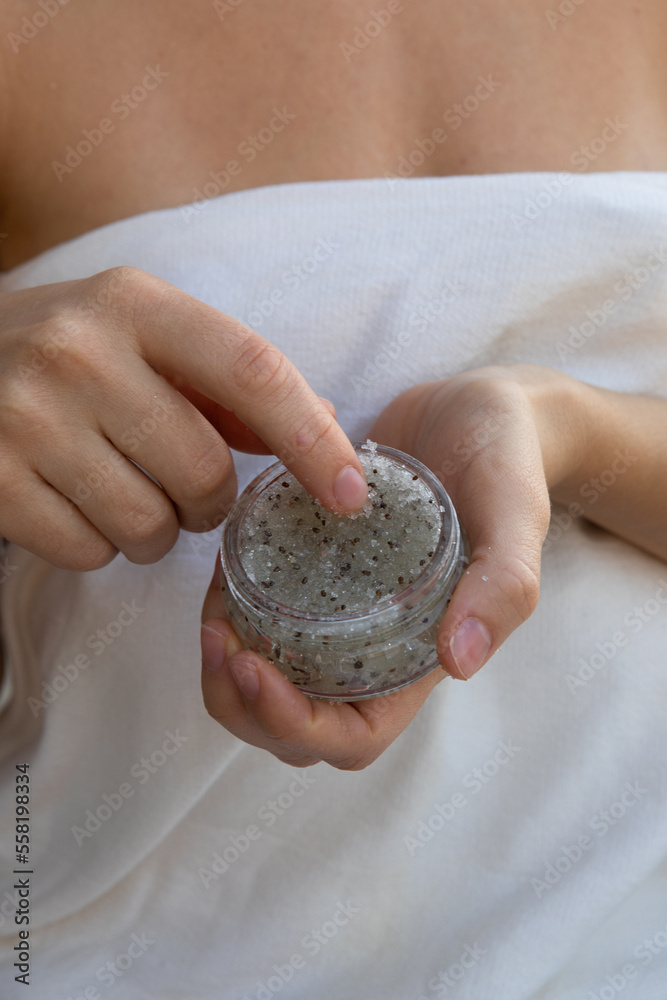 Beautiful young woman uses sugar scrub.Spa, skincare and wellness. Beautiful young woman uses sugar scrub.Spa, skincare and wellness.