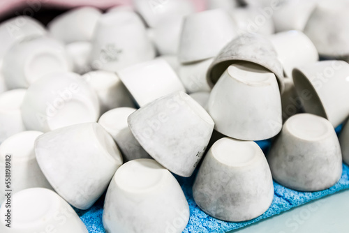 Pile of dirty white crucibles, drying in a laboratory