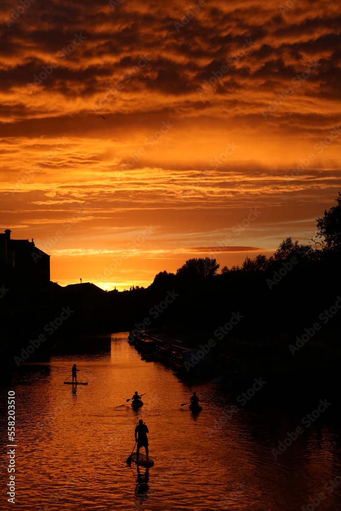 Stand up paddling at sunset on Avon River in Bath, England Great Britain