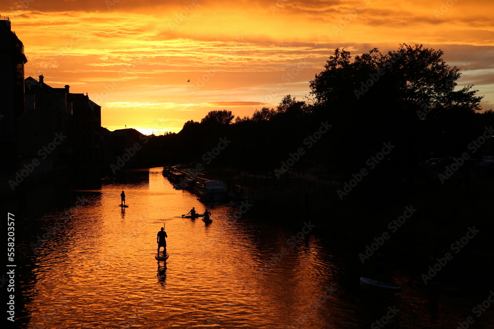 Stand up paddling at sunset on Avon River in Bath, England Great Britain Stand up paddling at sunset on Avon River in Bath, England Great Britain