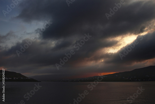 Fjord at night with storm clouds © Uladzimir