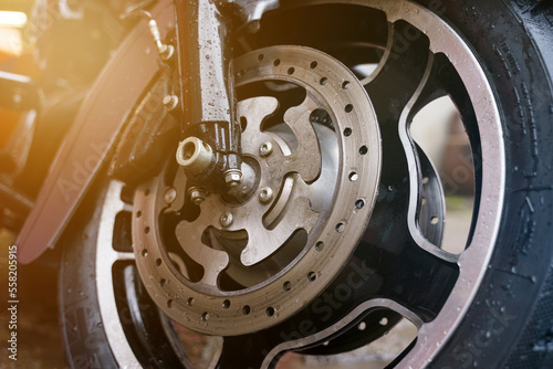 Fotografie Wheel and disc brake system of a motorcycle close-up.