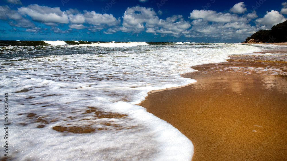 beautiful day and waves over the sea coast.