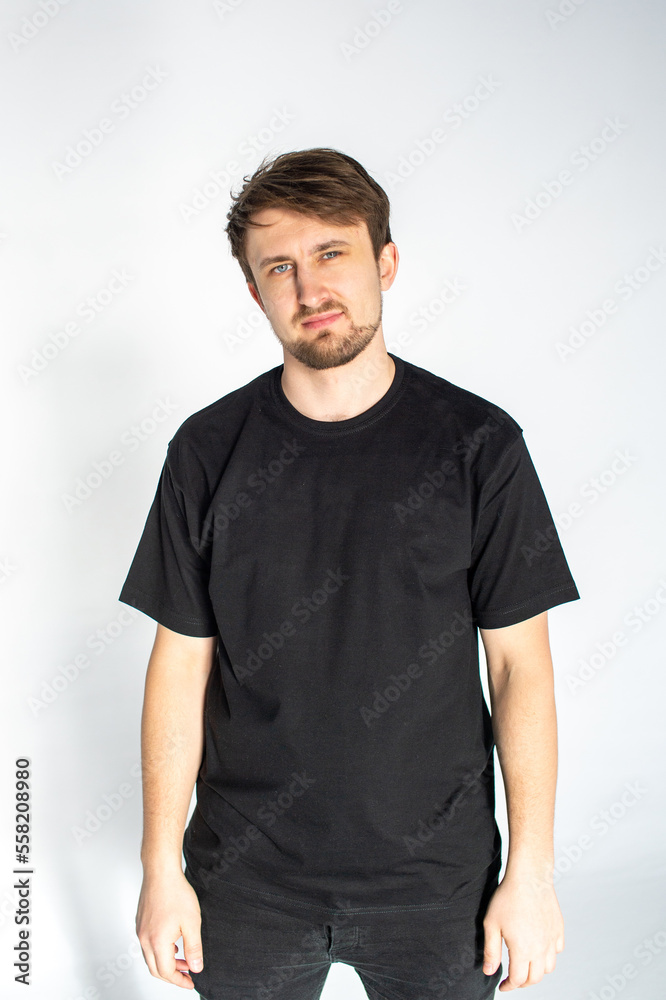 A young man is standing in a black T-shirt A young man is standing in a black T-shirt