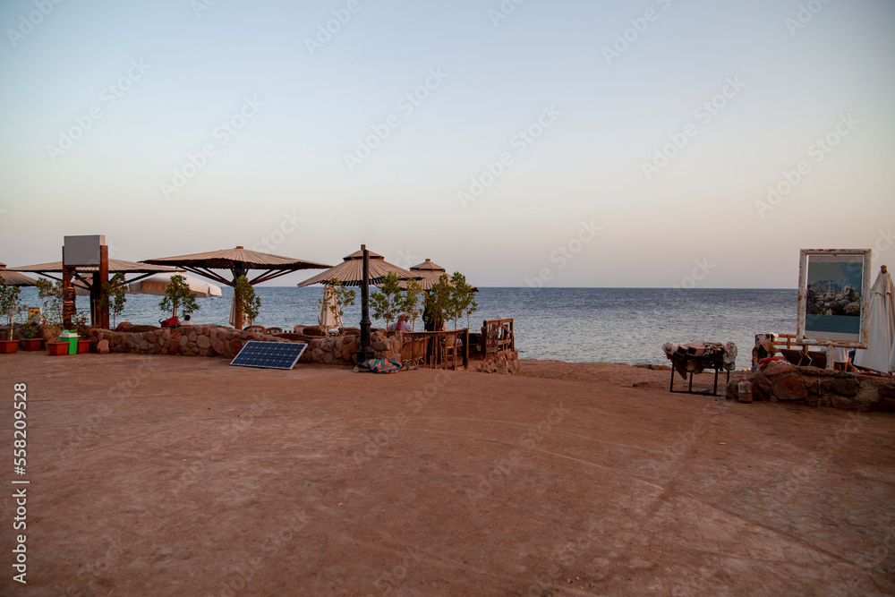 Red Sea coast, view of restaurant over sandy beach, Dahab, Egypt