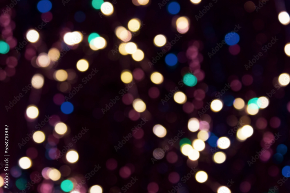 Christmas glowing garland with defocused multicolored lights. Colorful holiday background. Happy new year background.
