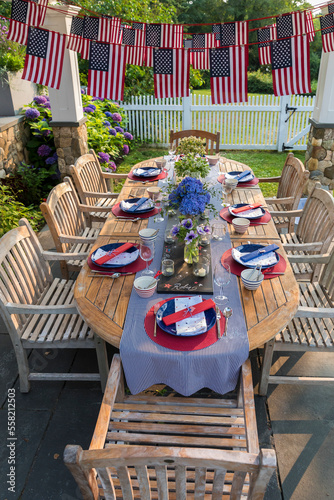 Festive Fourth of July party table set under garden pergola