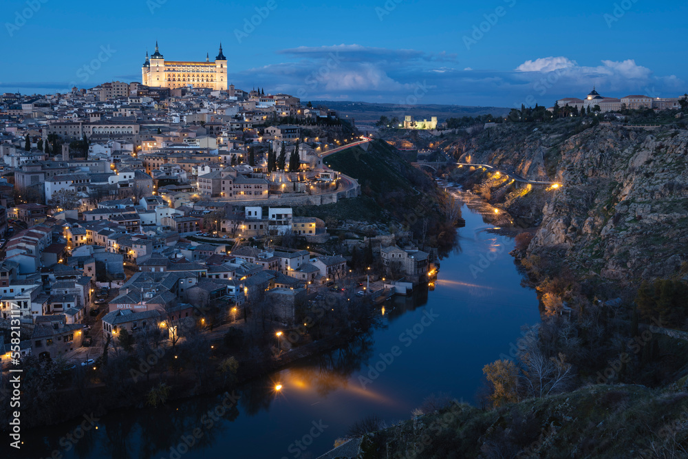 Alcazar de Toledo rises over city at dusk, Toledo, Spain