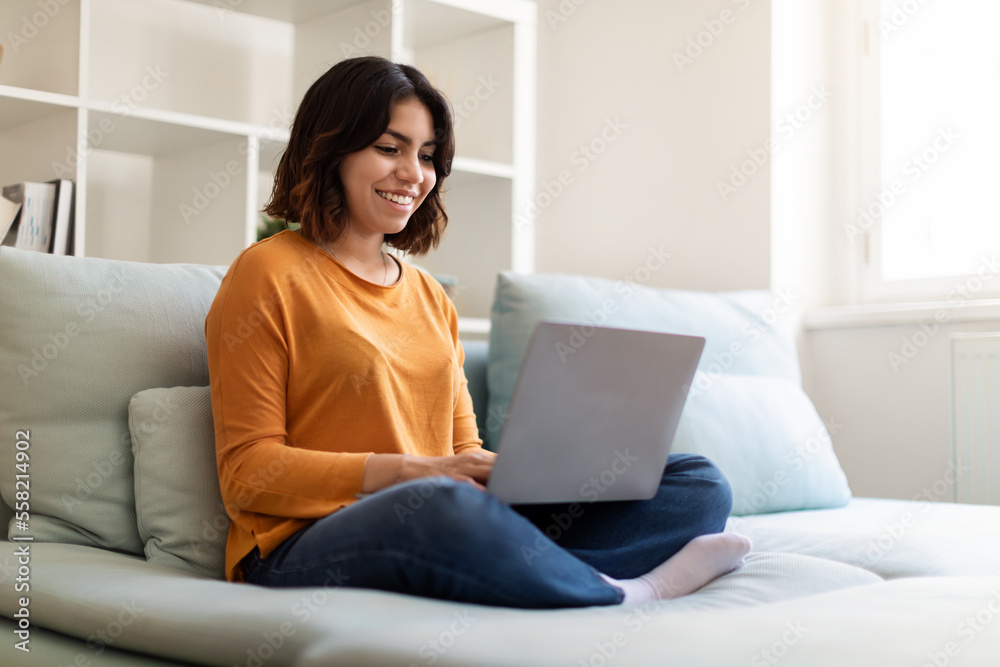 Online Communication. Portrait Of Beautiful Young Arab Woman Using Laptop At Home Online Communication. Portrait Of Beautiful Young Arab Woman Using Laptop At Home