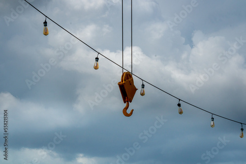 Cloudy sky with lamps and hook