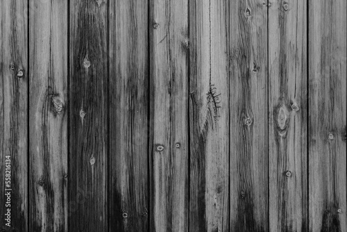 Vertical black and white vintage weathered textured stained wood panel wall for background texture in any abstract scene