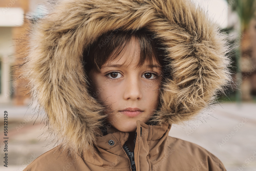 Close-up Of The Face Of A Beautiful Little Boy Wearing An Eskimo Hat On A Cold Day. Close-up Of The Face Of A Beautiful Little Boy Wearing An Eskimo Hat On A Cold Day.