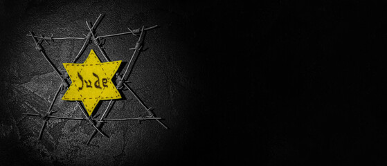 David star and barbed wire on dark background with space for text. International Holocaust Remembrance Day