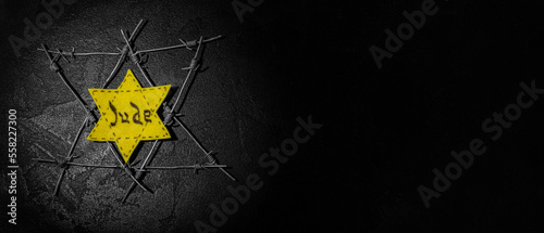David star and barbed wire on dark background with space for text. International Holocaust Remembrance Day