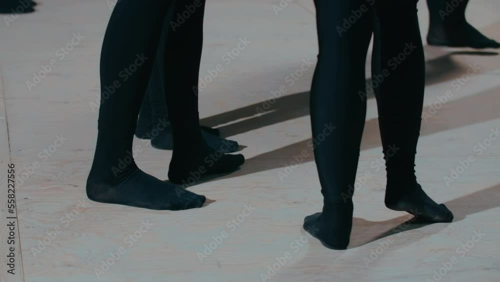 Slim female legs in black tights standing on wooden backstage in theater. Unrecognizable skilled young women rehearsing theatrical performance indoors Slim female legs in black tights standing on wooden backstage in theater. Unrecognizable skilled young women rehearsing theatrical performance indoors