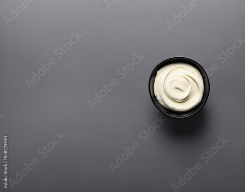 bowl of tasty mayonnaise on wooden background