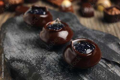 Dark board with chocolate c...