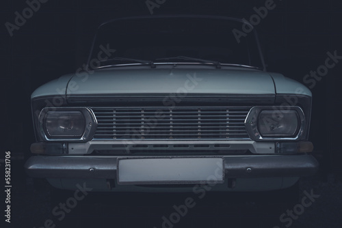 Close-up of front headlights and grille of a Soviet vintage car © kirill_makarov