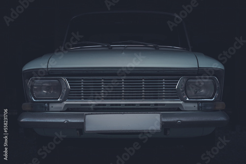 Close-up of front headlights and grille of a Soviet vintage car