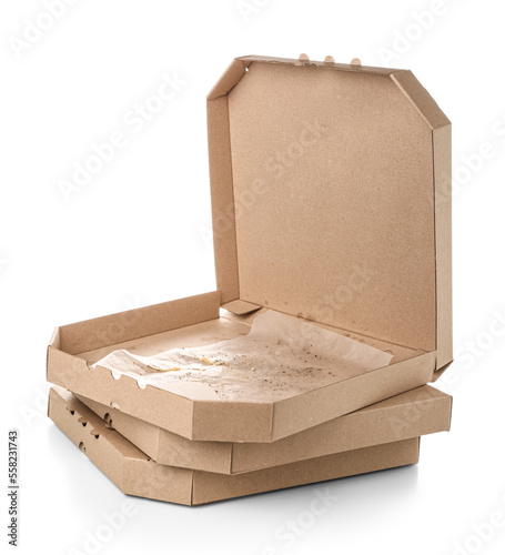 Stack of cardboard greasy pizza boxes on white background
