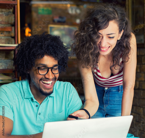 Woman and man students study in the coffee shop using laptop and tablet 