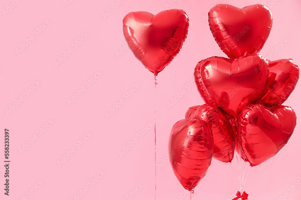 Heart-shaped balloons for Valentine's Day on pink background