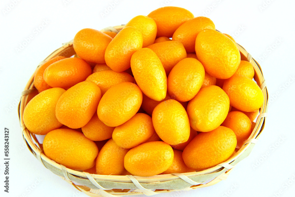 Kumquats in a basket on a white background
Kumquats in a basket on a white background