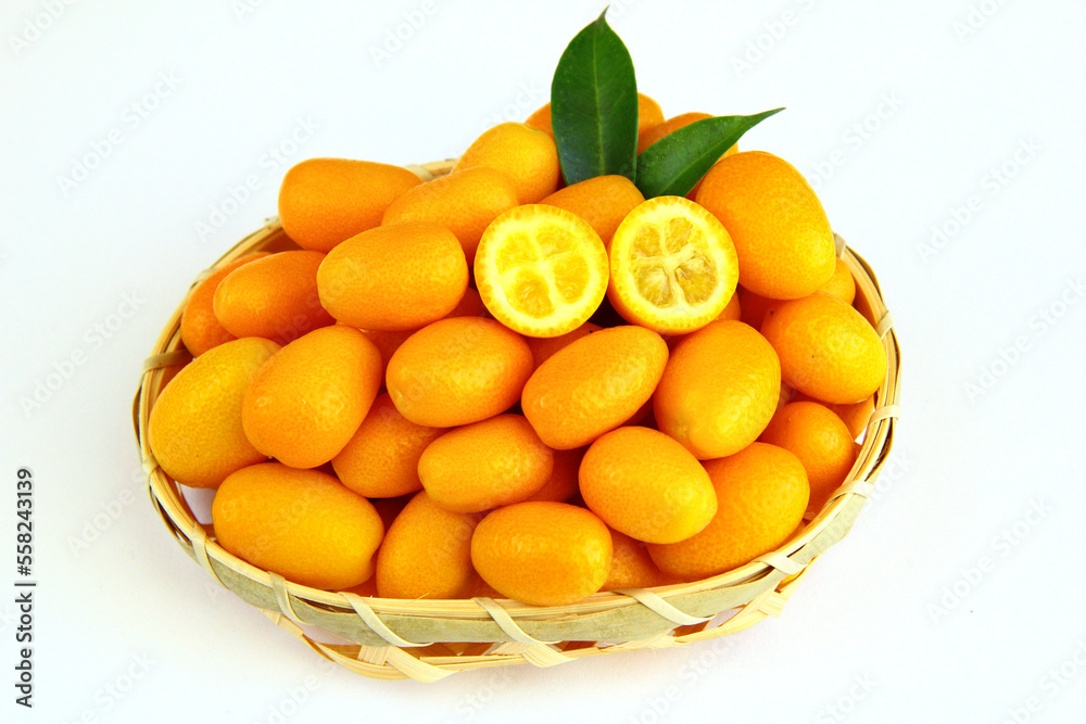 Kumquats in a basket on a white background
Kumquats in a basket on a white background