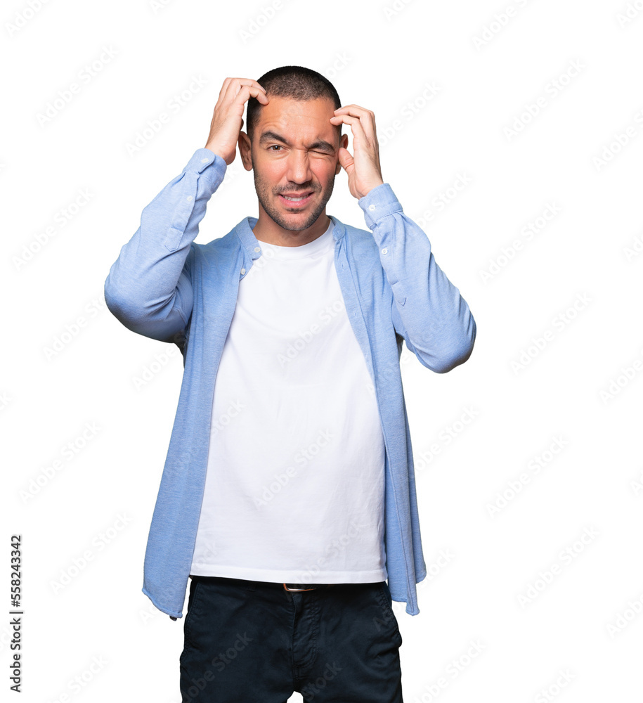 Concerned young man making a scratching gesture Concerned young man making a scratching gesture