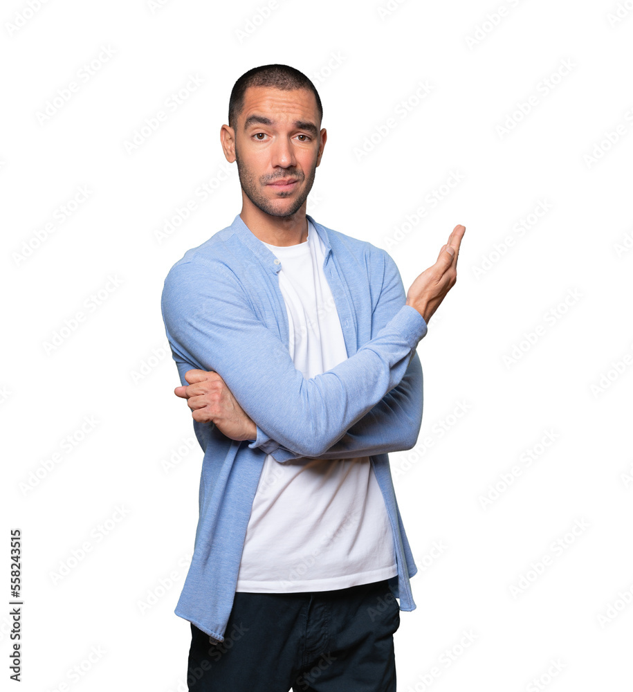 Puzzled young man doing a gesture of not understand