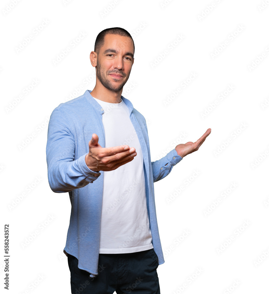 Happy young man doing a gesture of welcome with his hand Happy young man doing a gesture of welcome with his hand