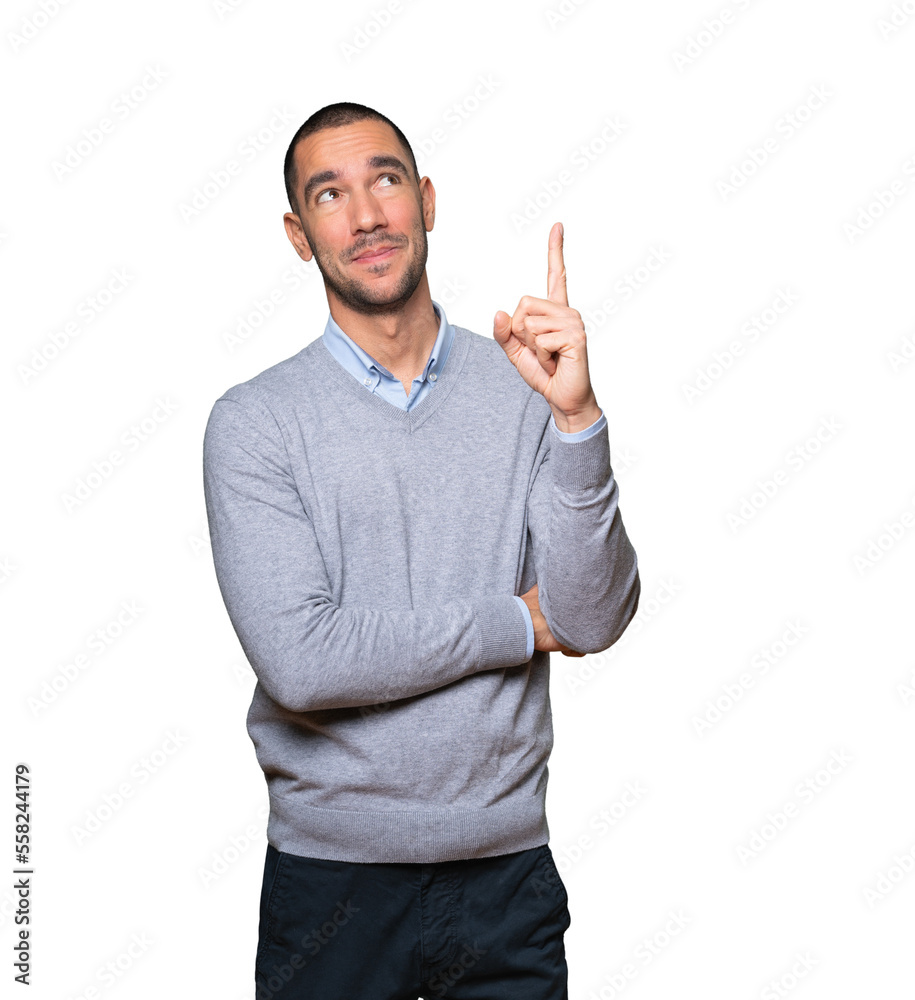 Happy young man pointing up with his finger Happy young man pointing up with his finger