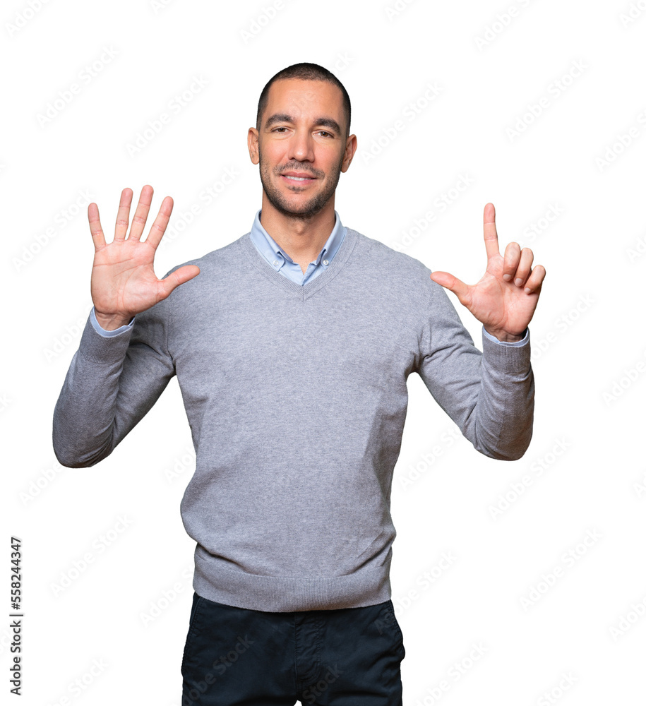 Happy young man doing a number seven gesture with his hands Happy young man doing a number seven gesture with his hands