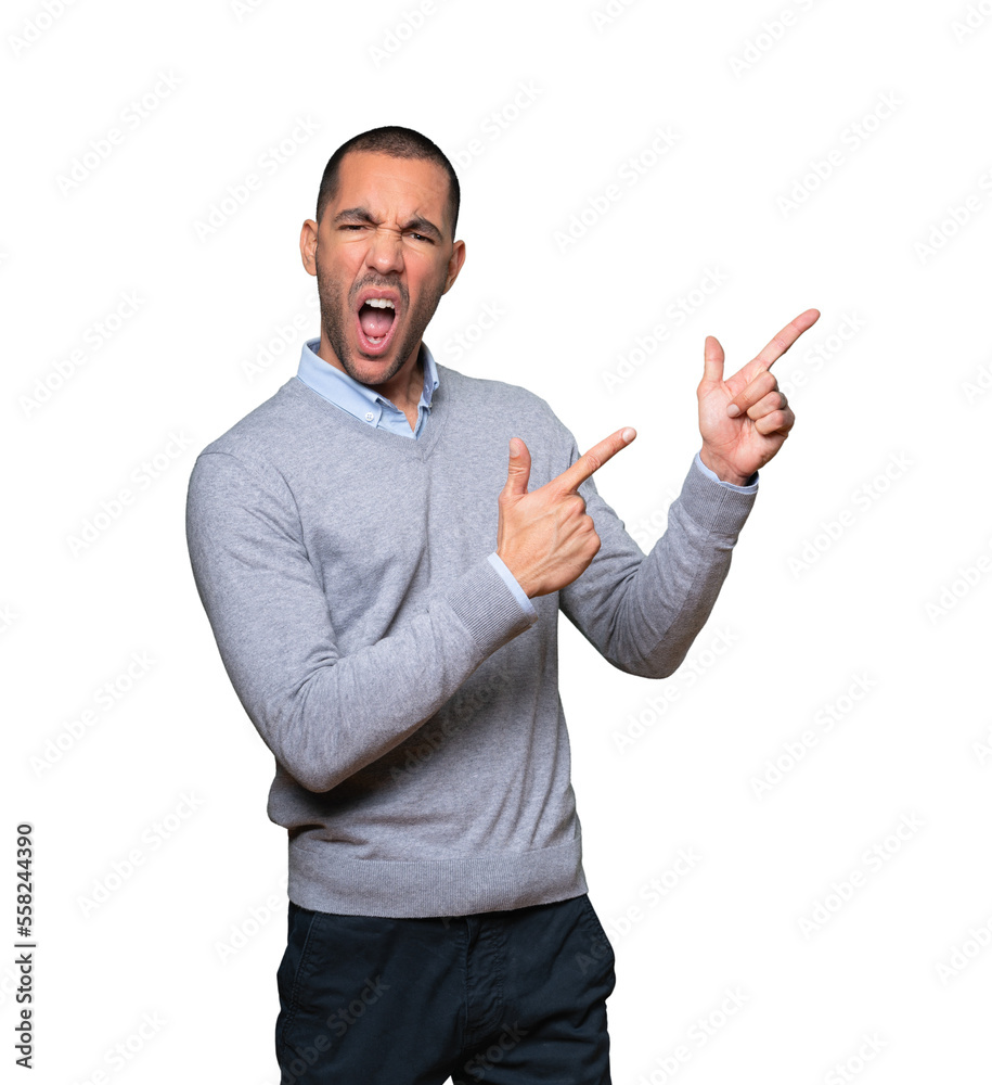 Cool young man pointing with his fingers Cool young man pointing with his fingers