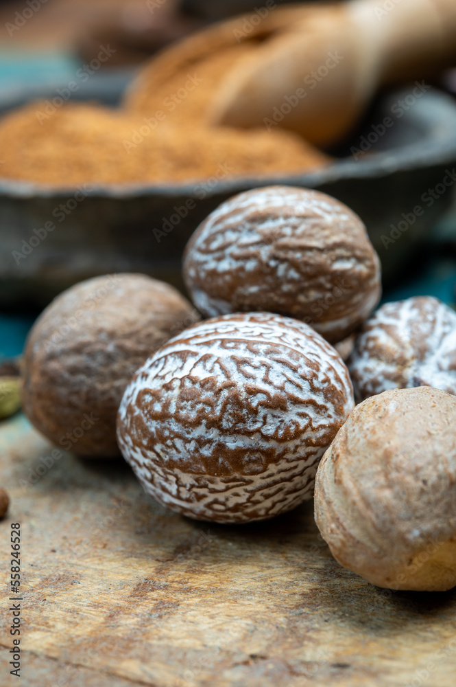 Nutmeg powder. Macro view whole nuts and grated muscat nuts on vintage background.