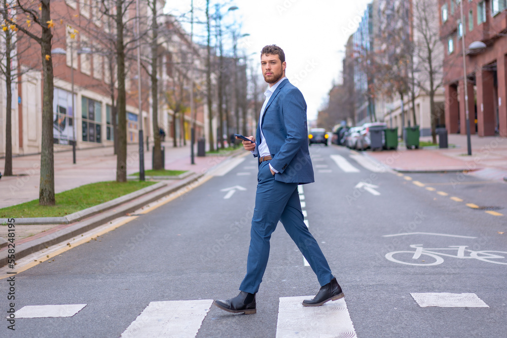 Businessman or finance man crossing a zebra crossing heading to the office at the time of rest Businessman or finance man crossing a zebra crossing heading to the office at the time of rest