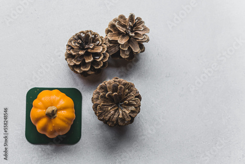Decoration with pumpkin cake and cones standing on gray table. High angle view. Copy space. High quality photo