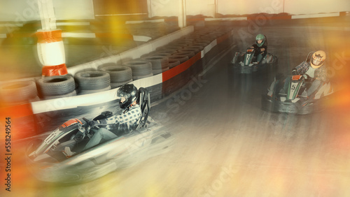 Wallpaper Mural sportive positive man and women competing on racing cars at kart circuit Torontodigital.ca