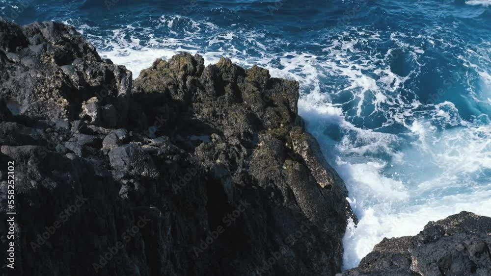 A big waves of the Atlantic Ocean breaks on a rocky coast on a sunny day during a storm in in the Canaries. Tenerife, Spain of Island Tenerife. Slow mtion 4k shot A big waves of the Atlantic Ocean breaks on a rocky coast on a sunny day during a storm in in the Canaries. Tenerife, Spain of Island Tenerife. Slow mtion 4k shot
