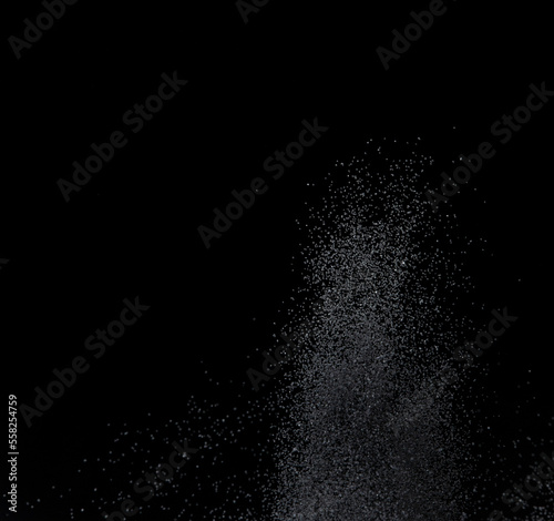 Million of black sand explosion, Photo image of falling down sands flying. Freeze shot on black background isolated overlay. Tiny Fine sand dust magnet as particle disintegrate science