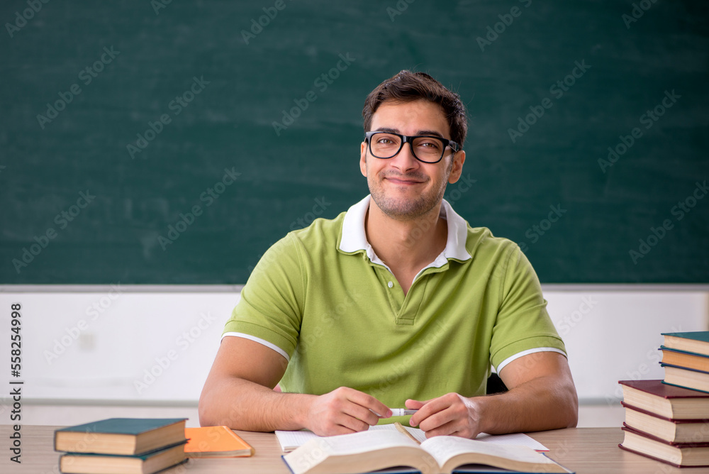 Young male student sitting in the classroom Young male student sitting in the classroom