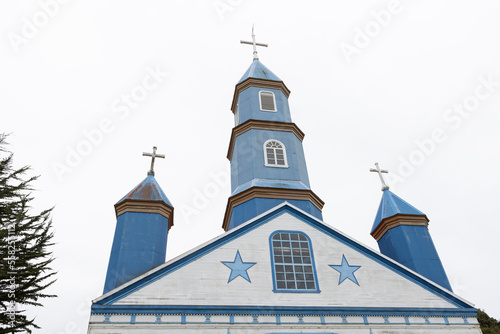Beautiful church (Iglesia de Tenaún) completely made of wood and painted in blue and white in Tenaún on Chiloé (Isla Grande de Chiloé) in Chile  photo