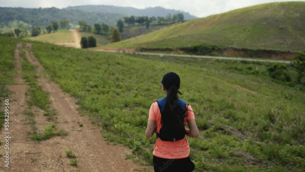 Woman practicing trail running in the mountains Woman practicing trail running in the mountains