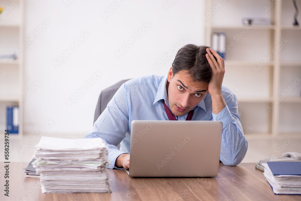 Young male employee working in the office Young male employee working in the office
