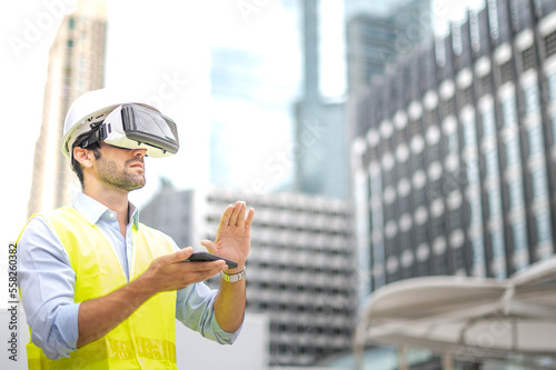 Caucasian man use VR glasses watching video for entertainment, work, free time and study, while hand holding a smartphone for control the VR glasses.
